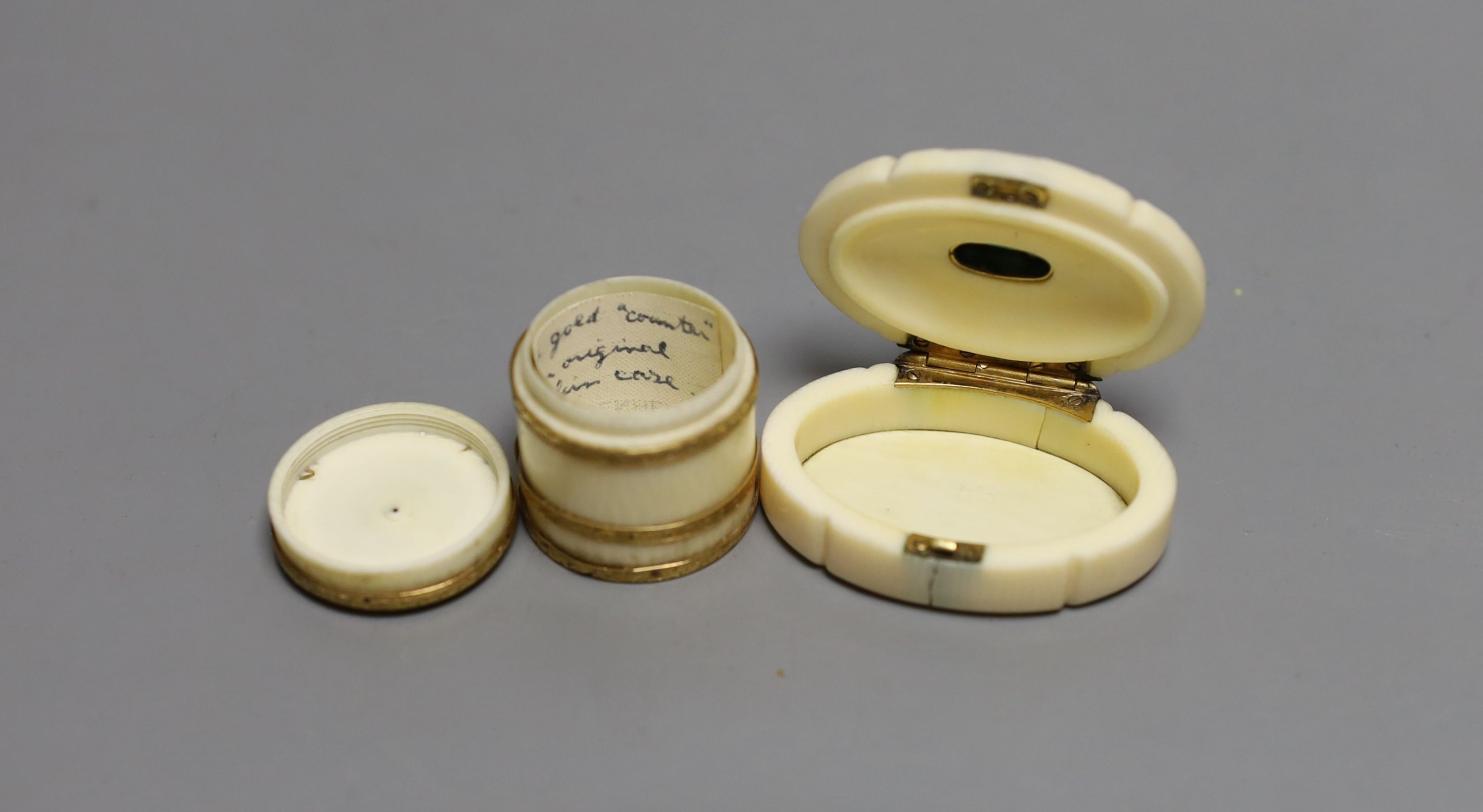 An 18th century yellow metal banded ivory counter box and oval ivory green cabochon mounted snuff box, Counter box 3cms high.